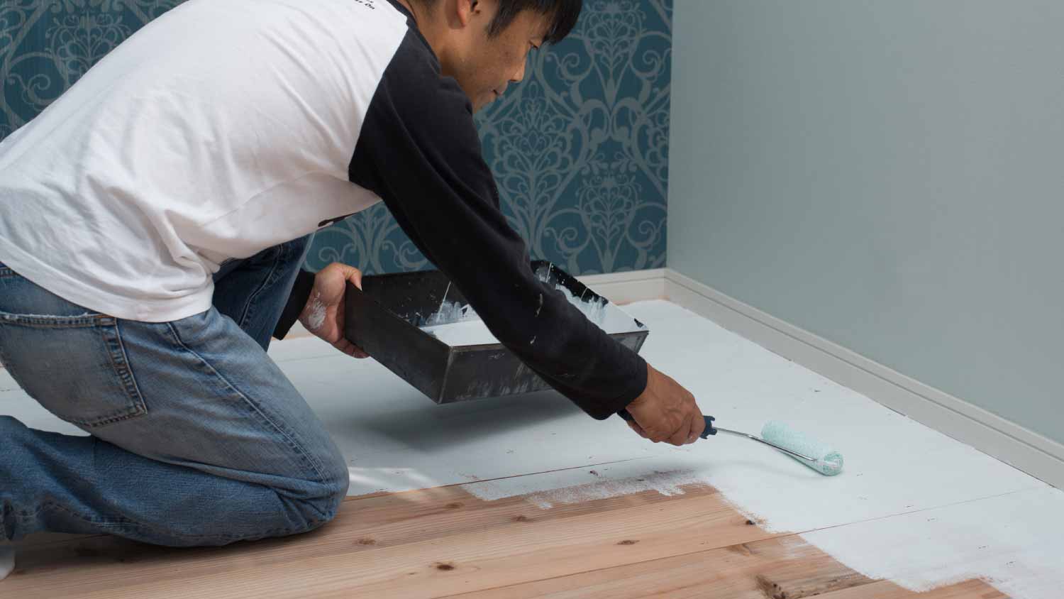 Man painting hardwood floors