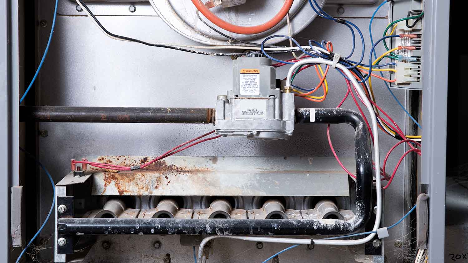 a white home furnace with heating pipes