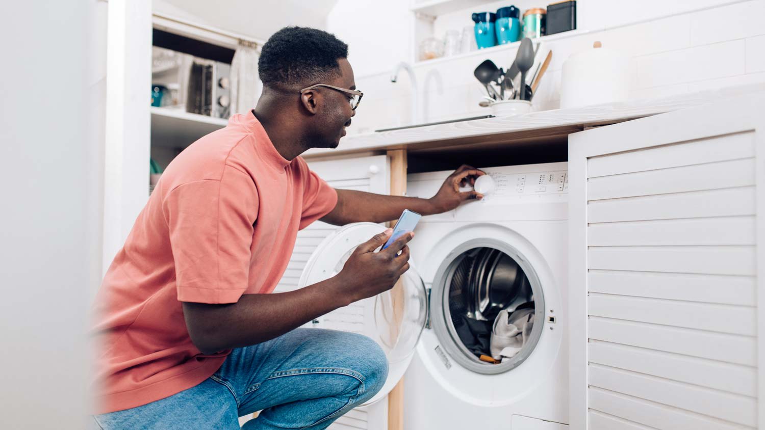 A man turning on a washing machine