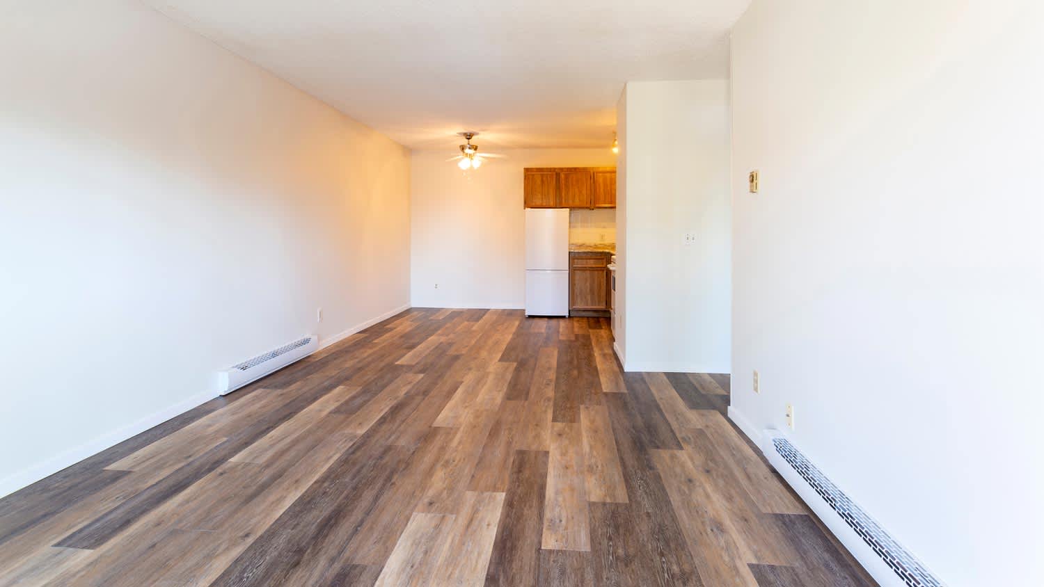 A vacant room with baseboard heaters