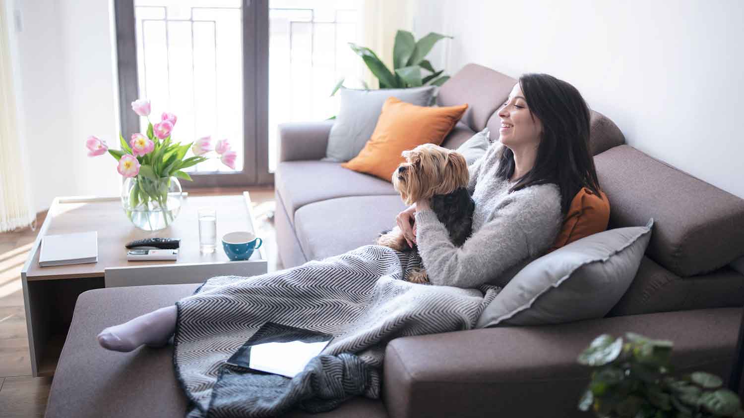 Woman sitting on the couch with her dog