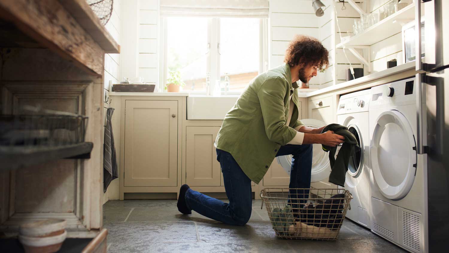 A man loading a front load washing machine