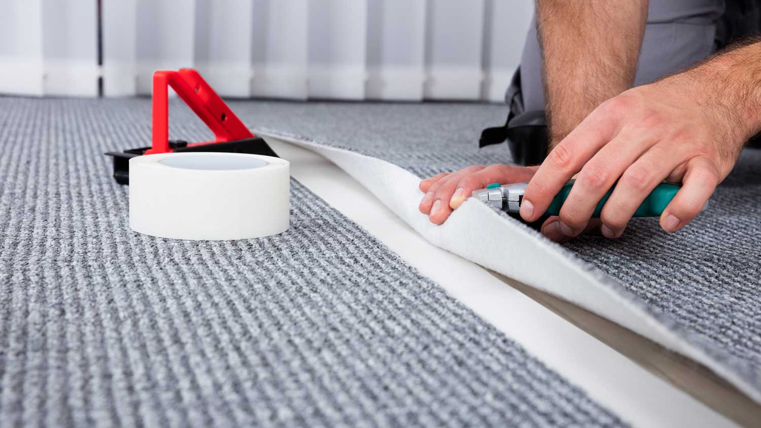 A person installing a carpet replacement piece