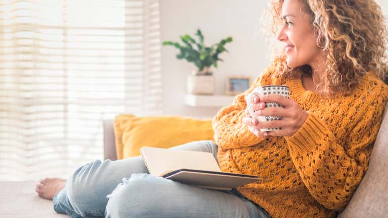 Woman on sofa in yellow sweater