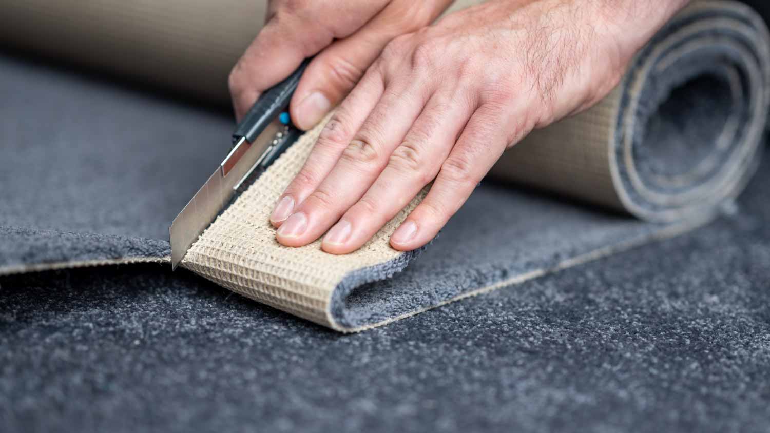 Man cutting a new carpet