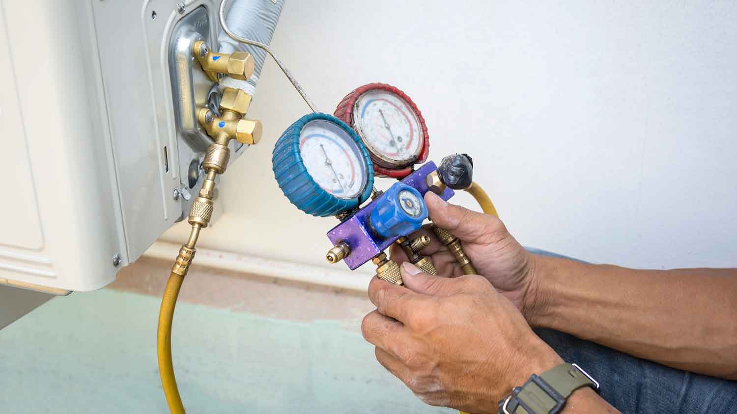 Technician checking ac refrigerant levels
