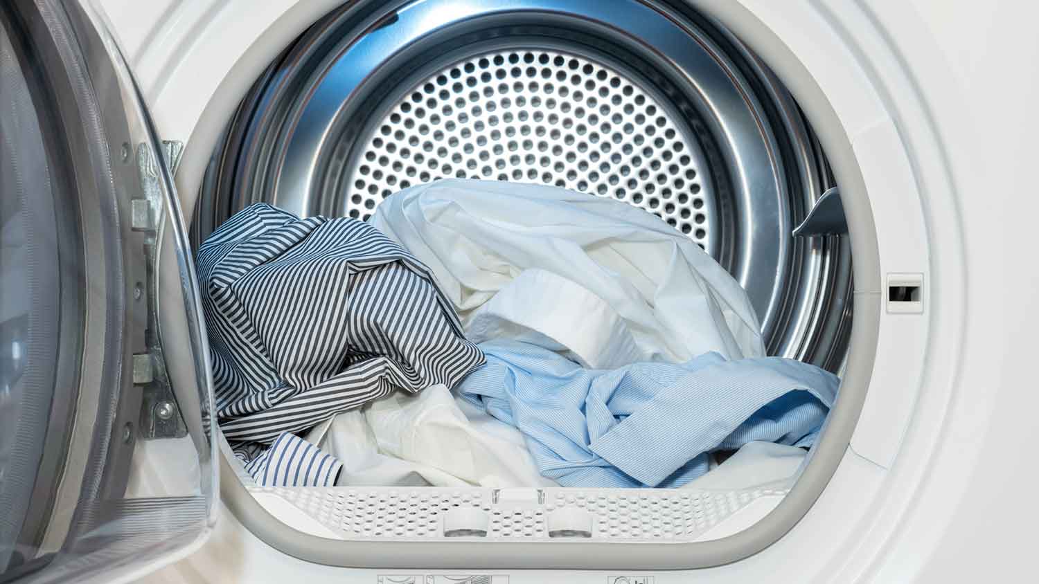 Dryer with open door and clothes in the drum