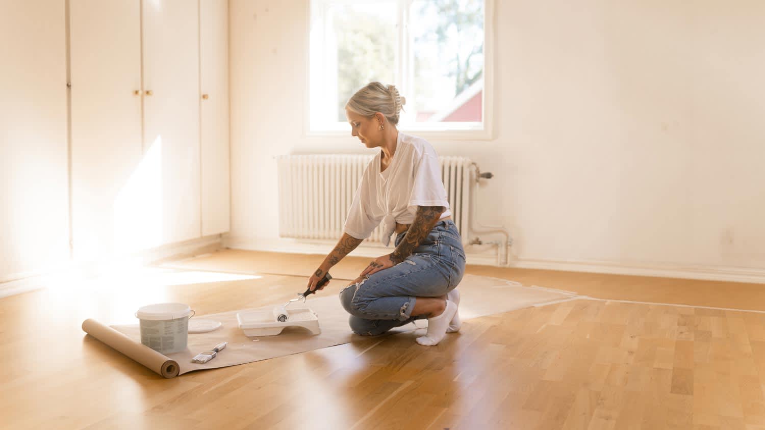 A woman preparing to paint laminate floor