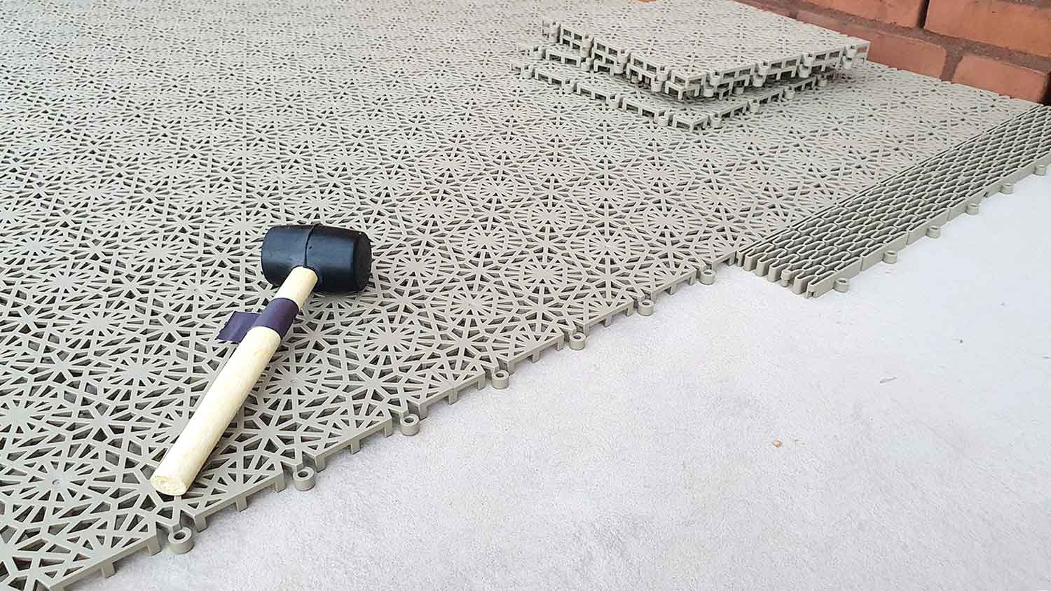 Plastic interlocking floor tile installation