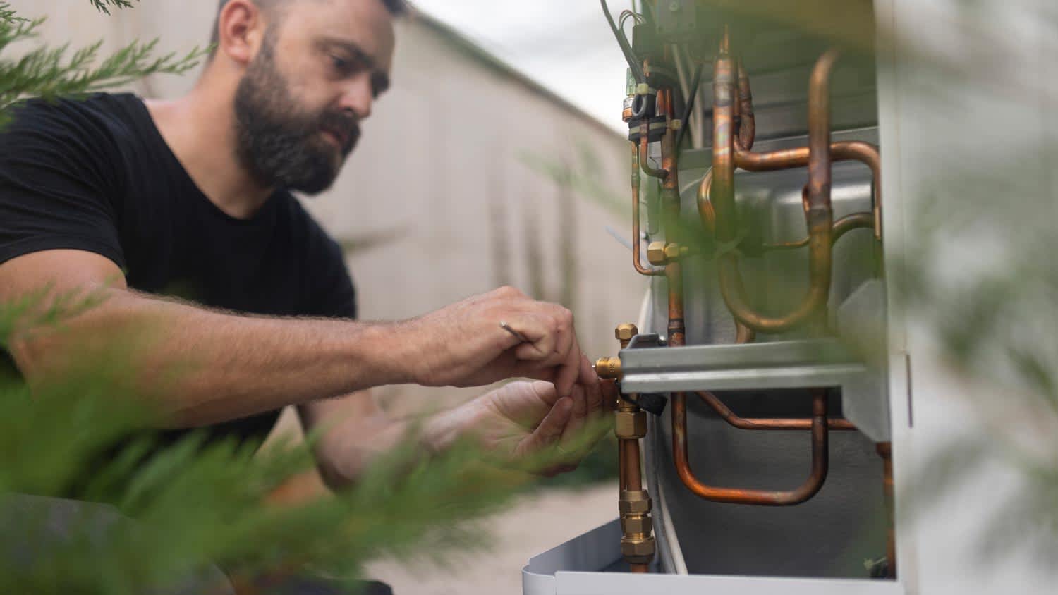 A man fixing a heat pump