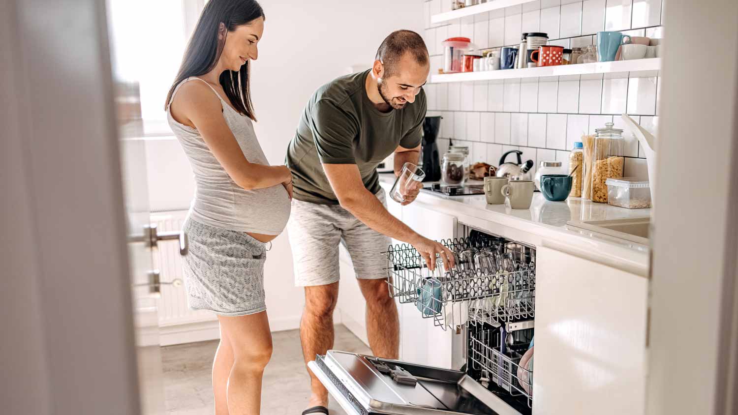 Couple cleaning dishwasher