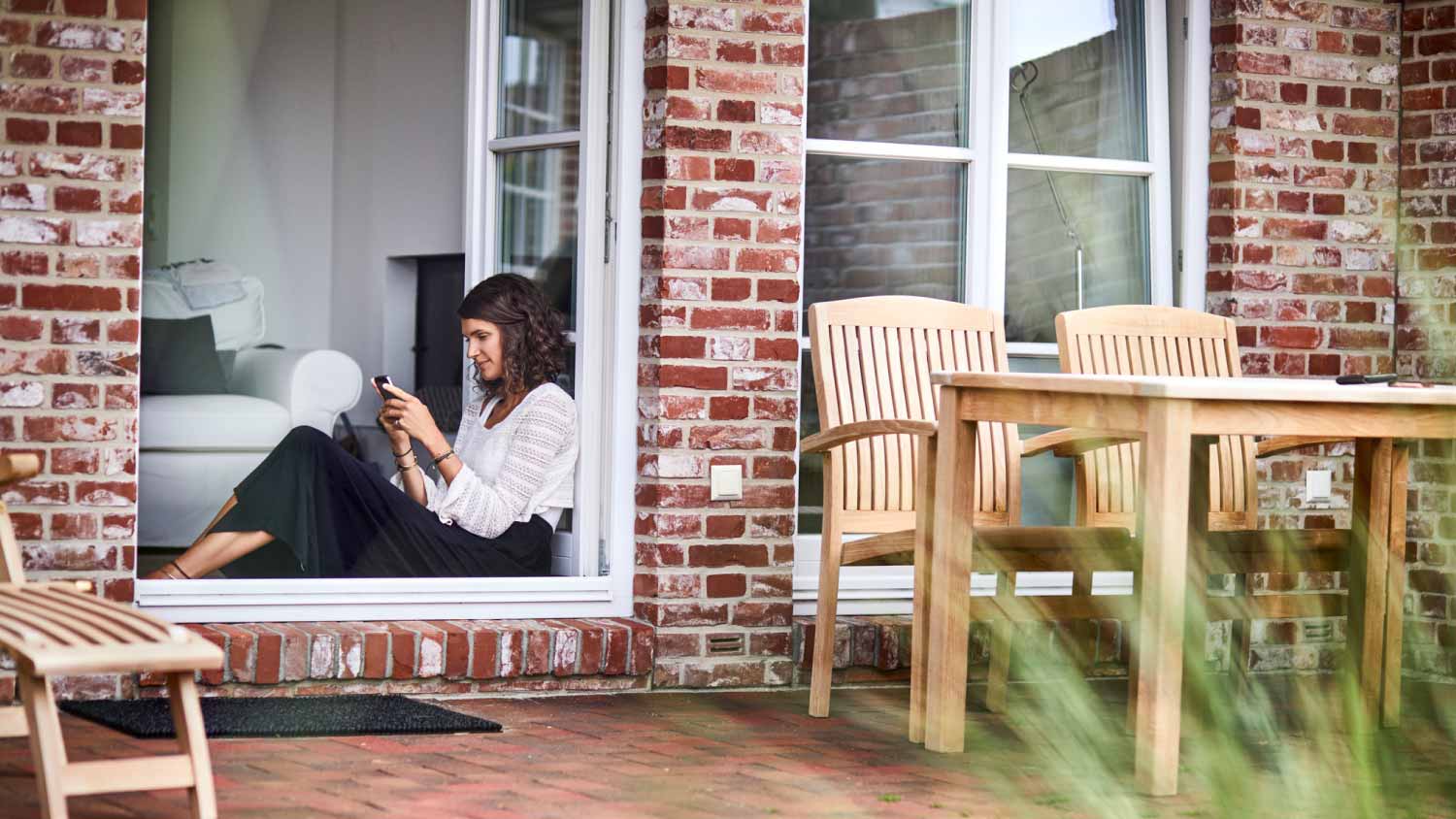 Woman sitting in window frame