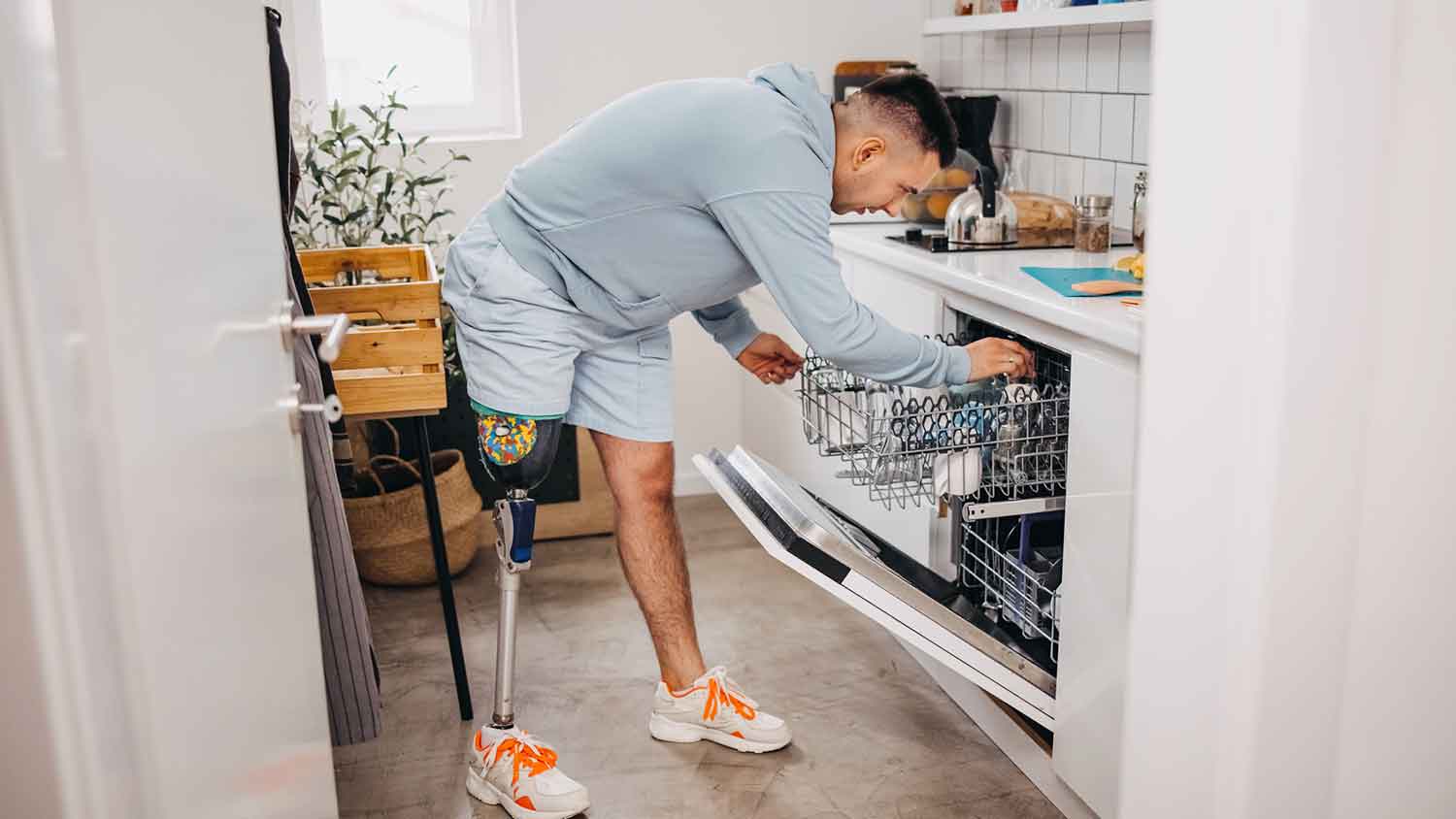 Man putting dishes in the dishwasher