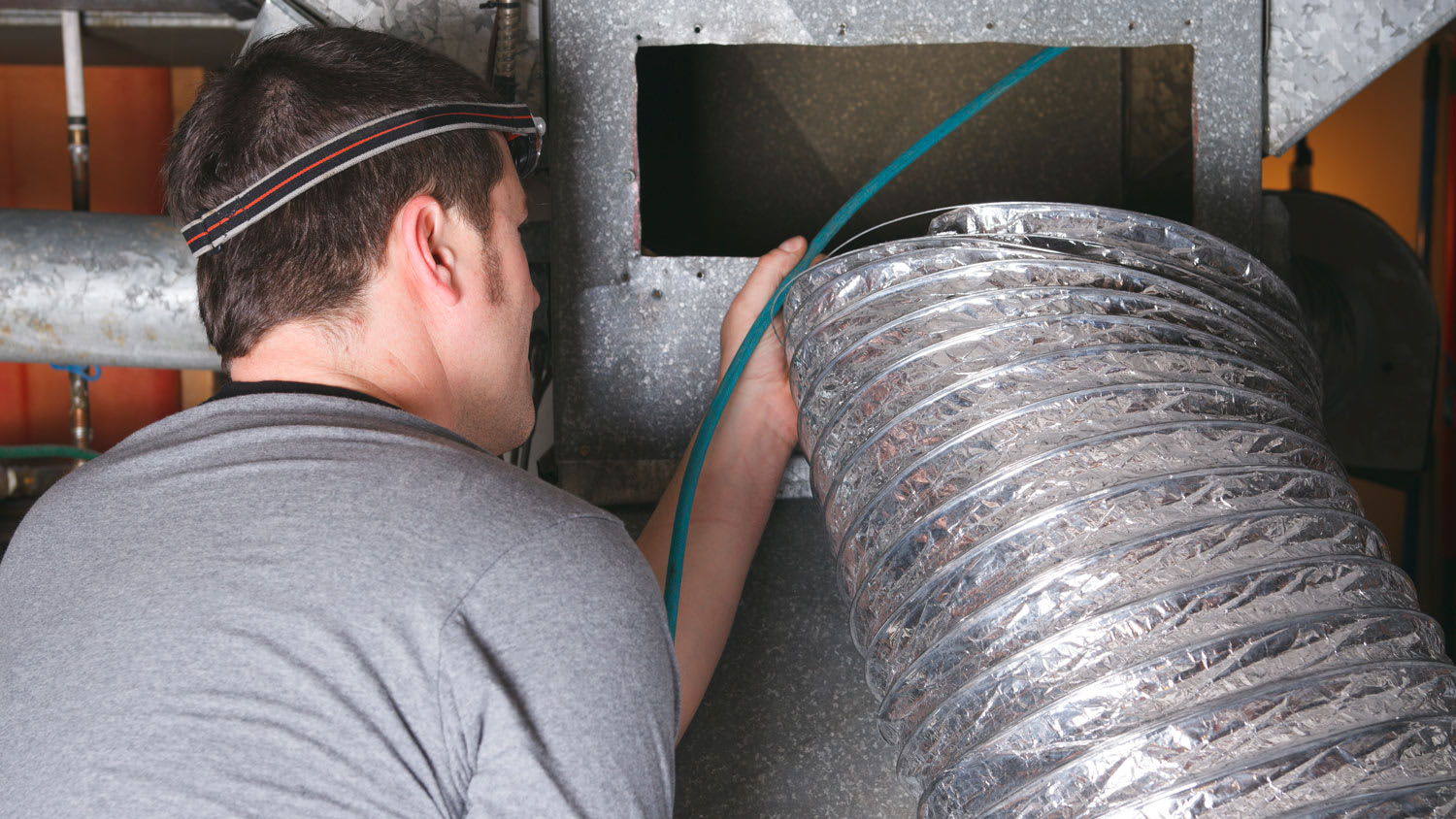 man checking air vent system