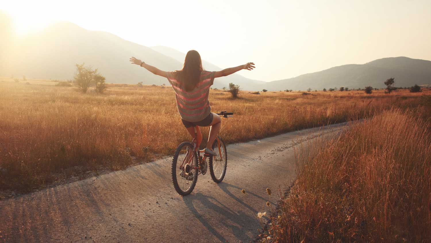 A woman cycling in the countryside