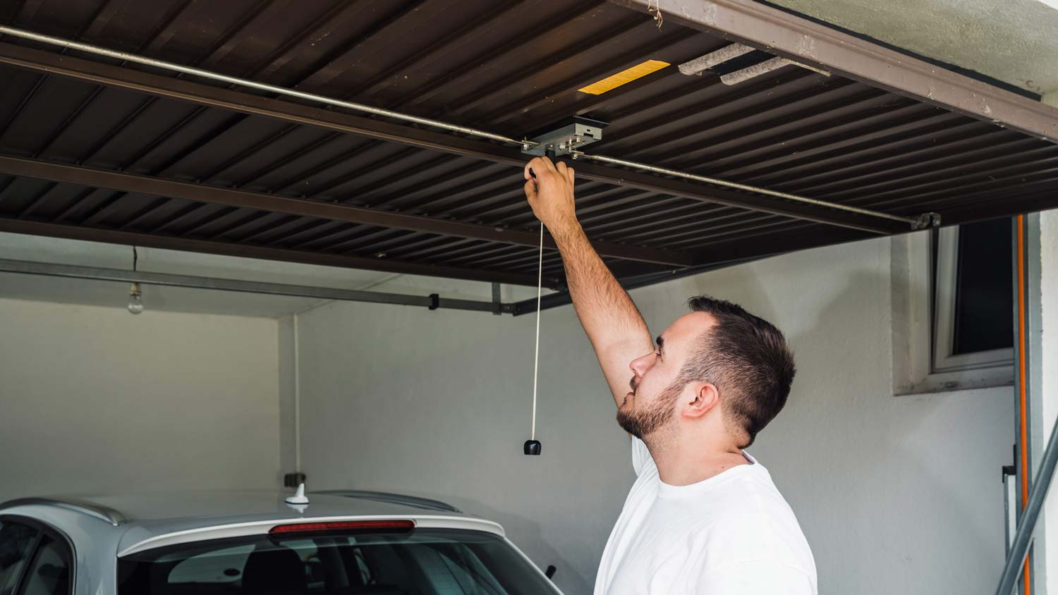 A man opening a garage door
