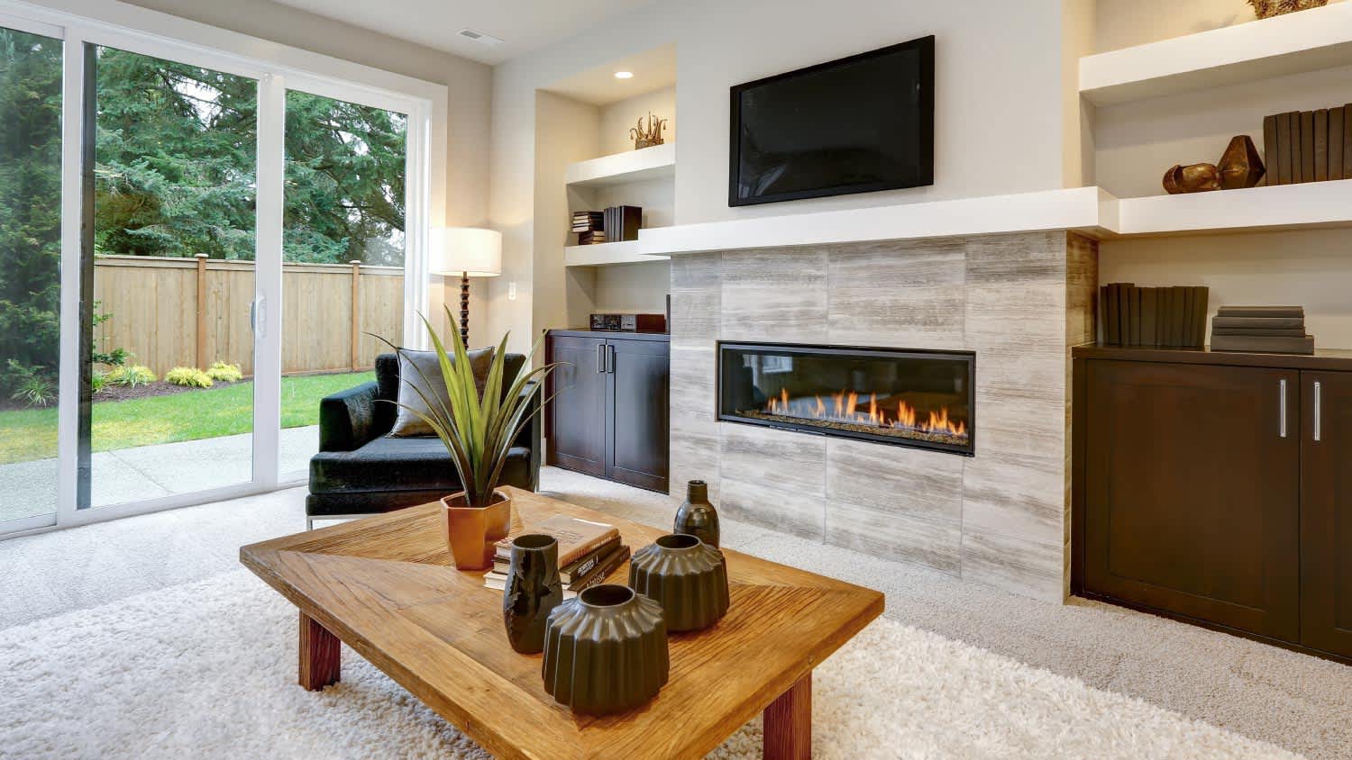 Living room interior with stone wall and fireplace