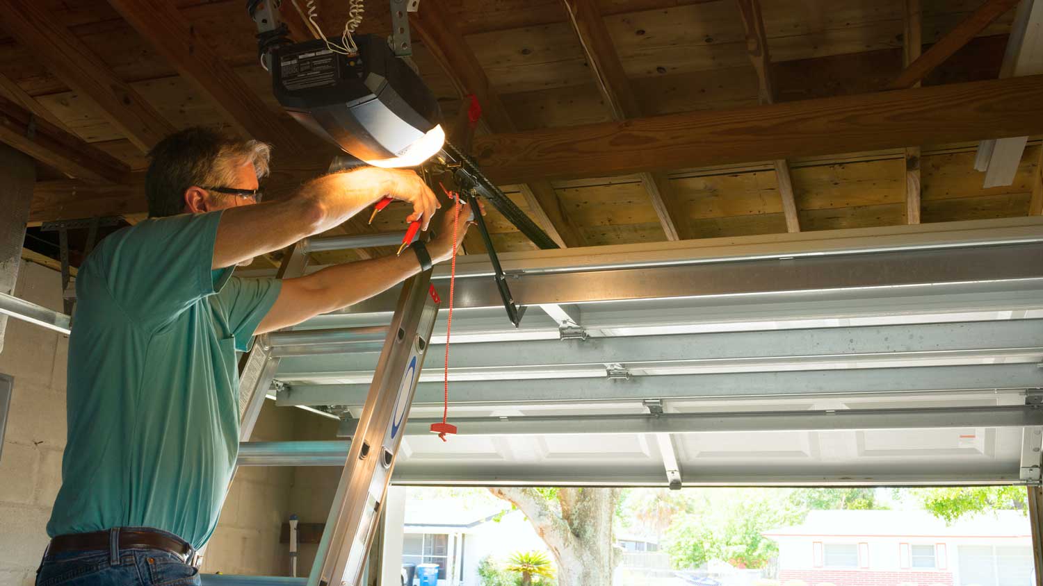 A man installing new garage door