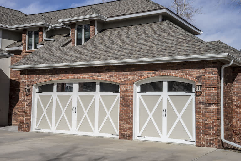 home garage with brick exterior and white garage door