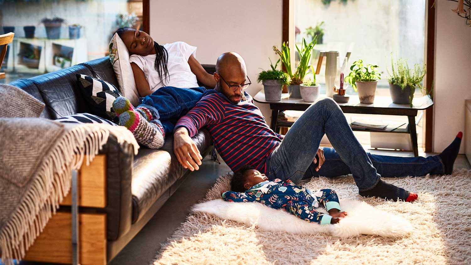 Parents and baby resting in the living room