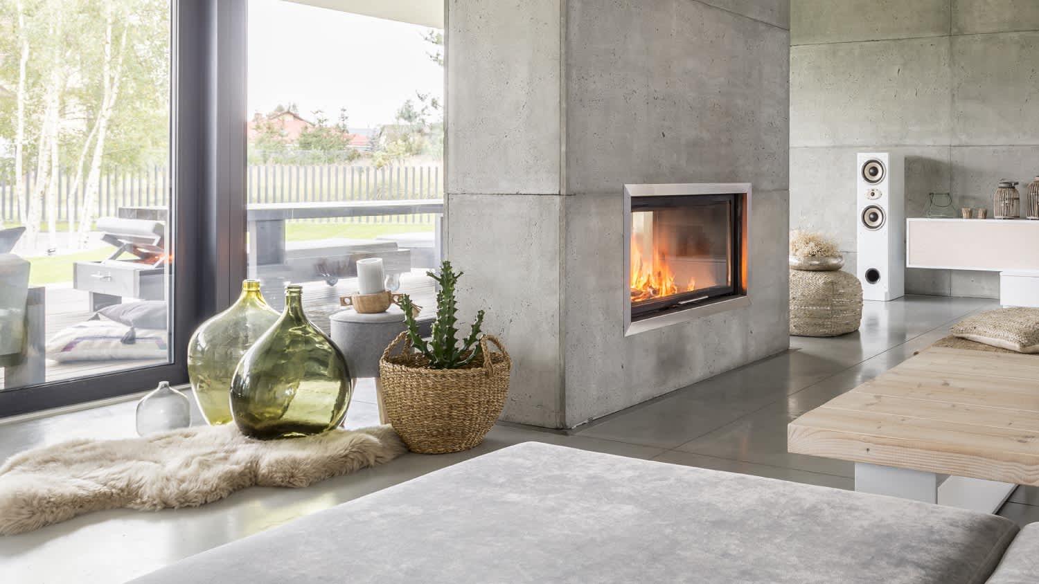 Living room interior with concrete wall and fireplace