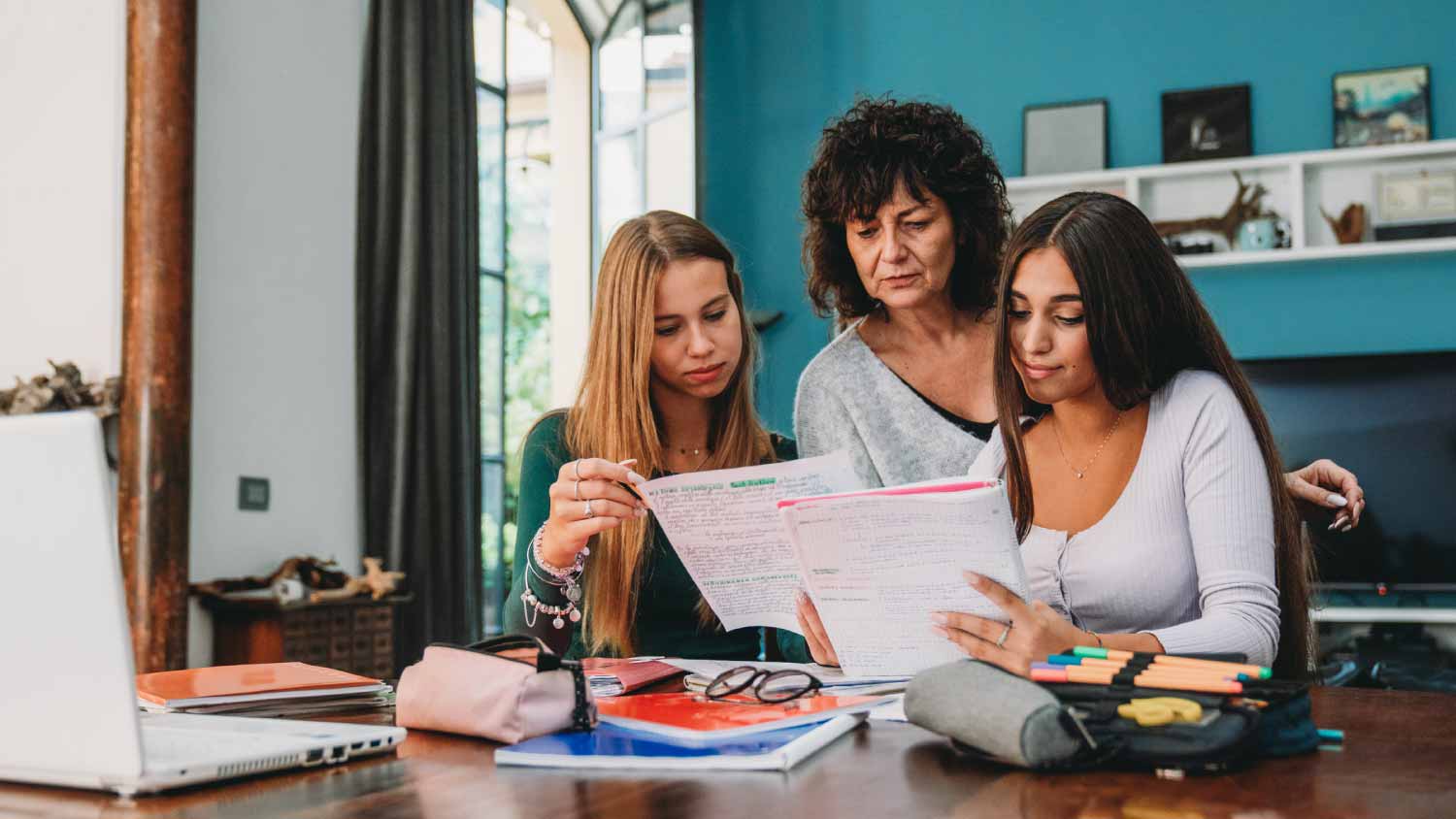 Mother and daughters checking documents