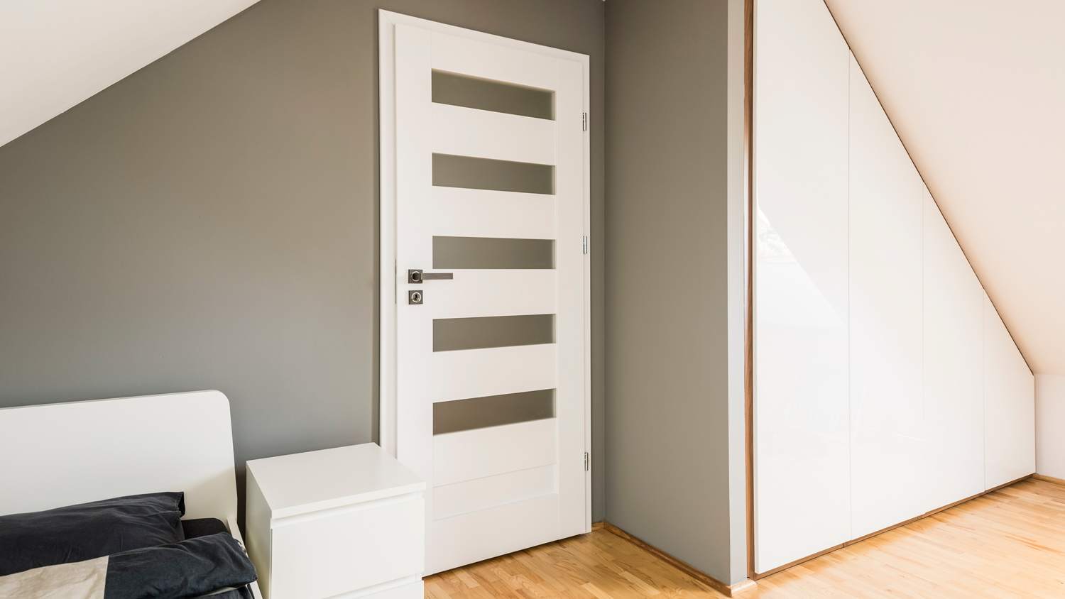 Attic bedroom with slanted storage unit