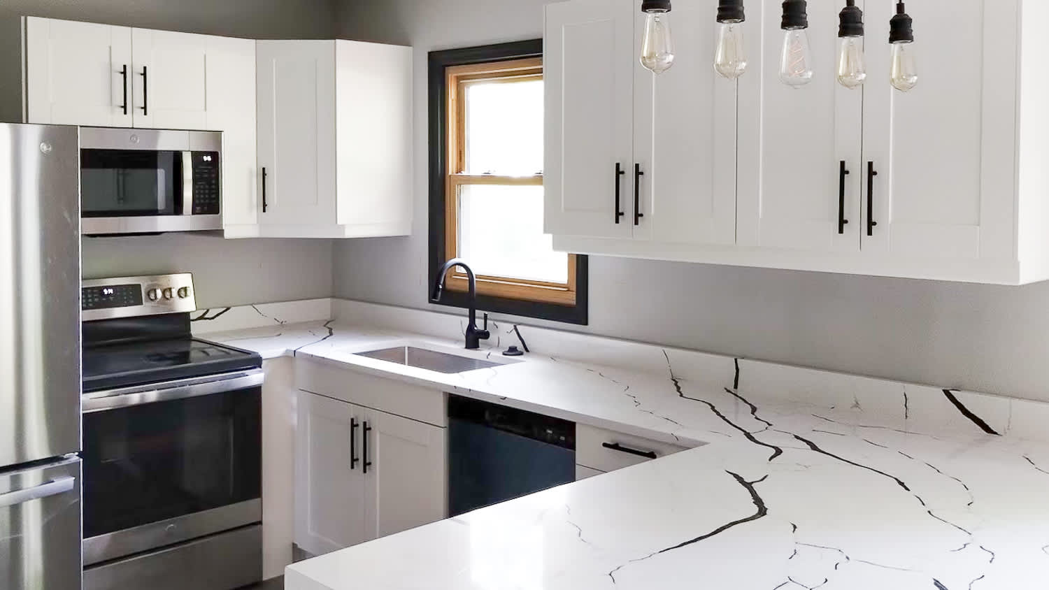 White kitchen with marble island