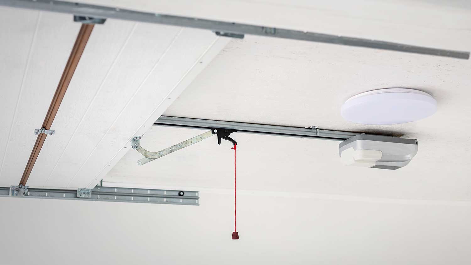 Automatic garage door opener mounted on the ceiling