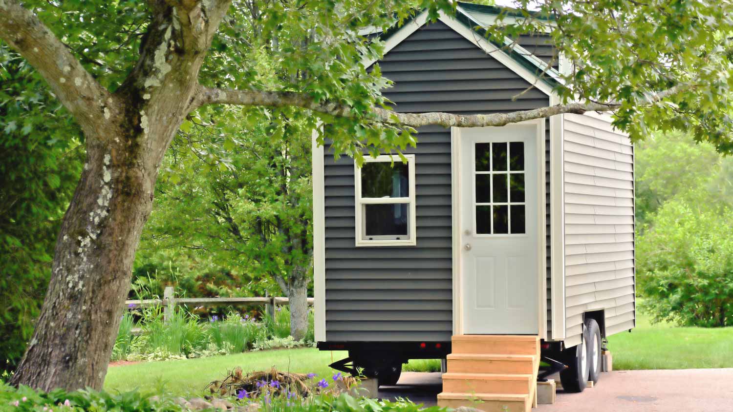 A tiny gray house on wheels