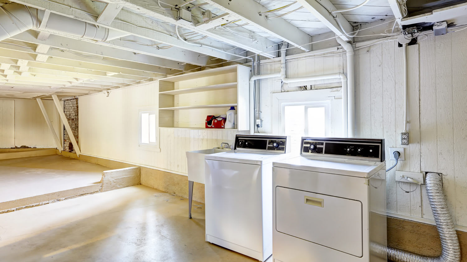 Empty basement in american house with laundry