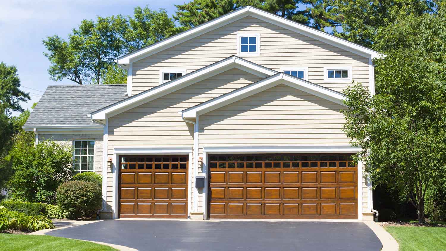 Hose with two wooden garage doors