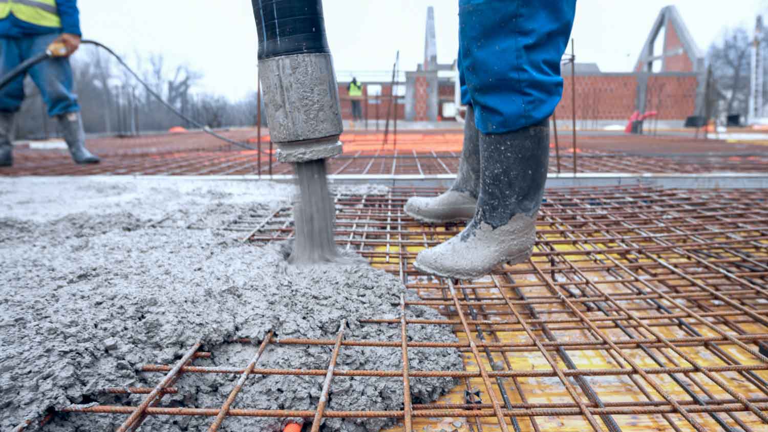 A worker pouring cement for foundation