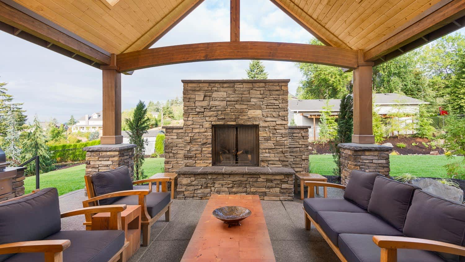 Patio with natural stone and fireplace