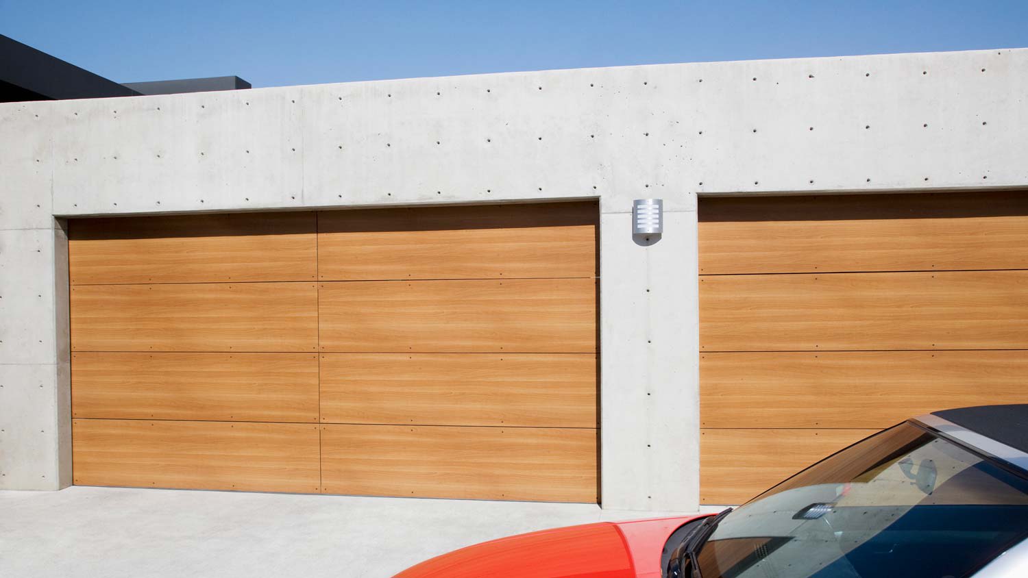 A contemporary house with minimal wooden garage doors
