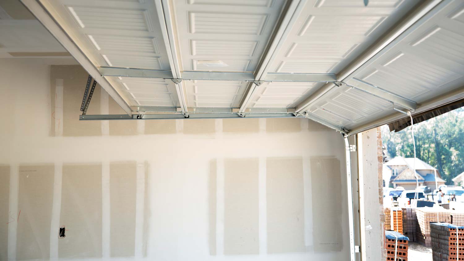 The interior of a garage with installed drywall