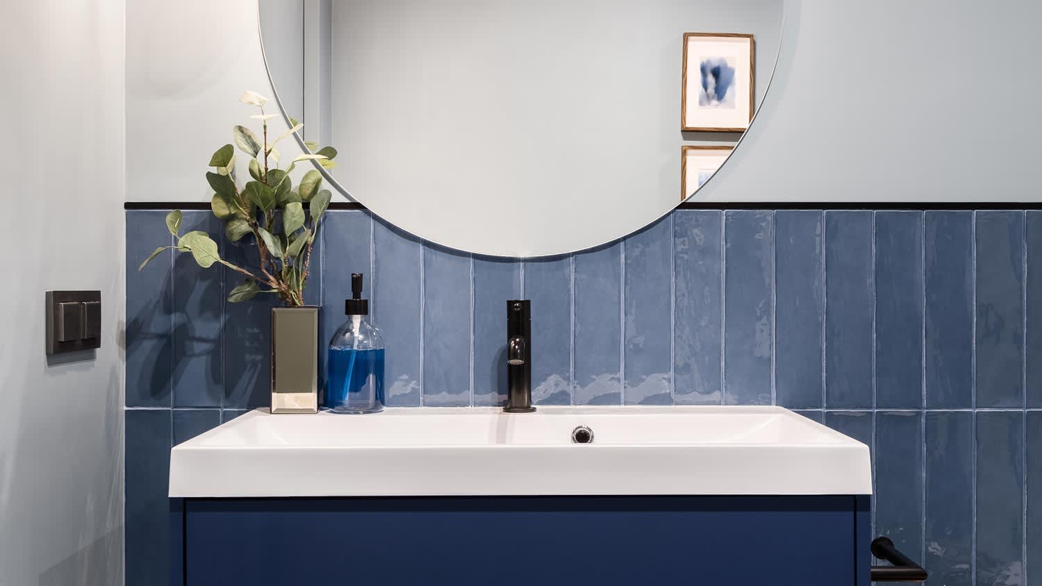 A minimal bathroom with blue tiles