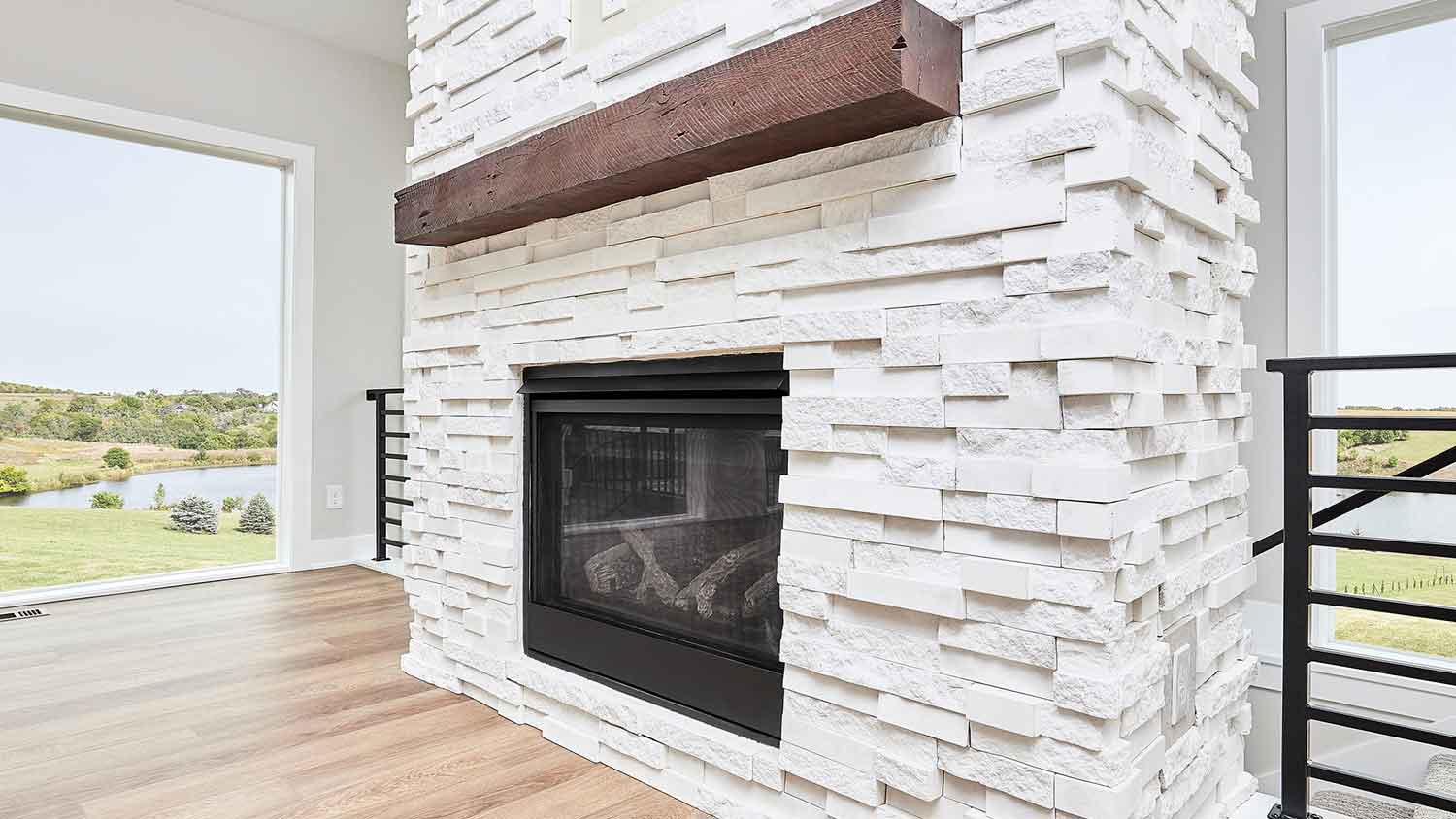 White stacked stone fireplace in a modern home