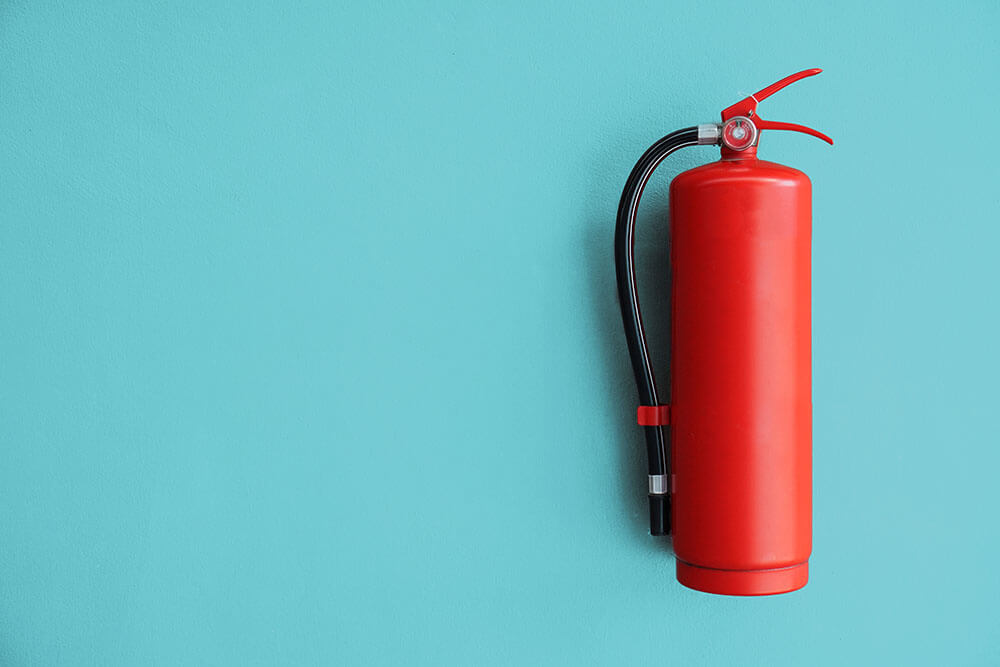 Fire extinguisher on blue wall