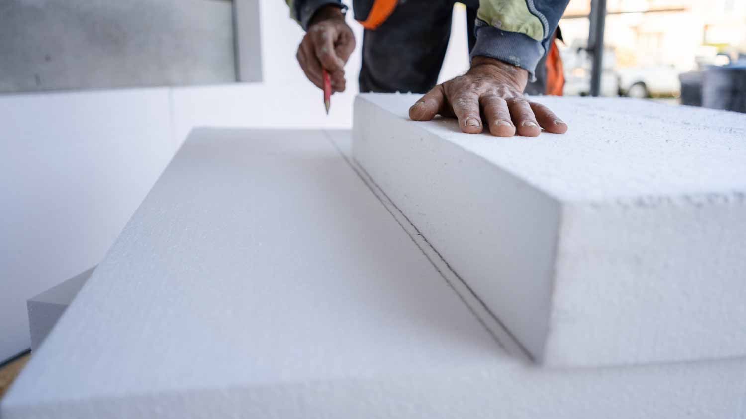 Worker using a pen to mark styrofoam