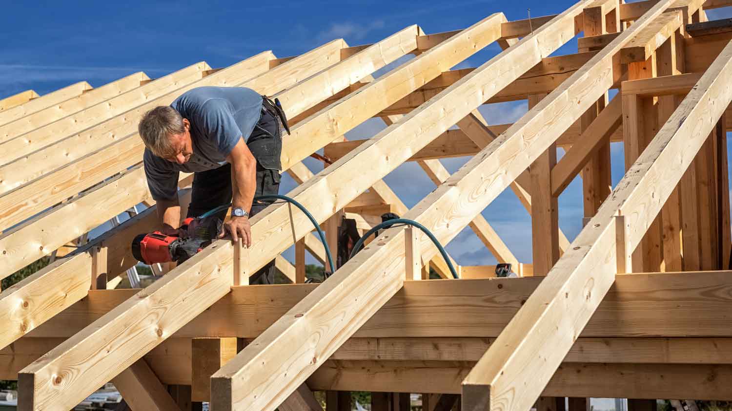 man installing hurricane ties to roof