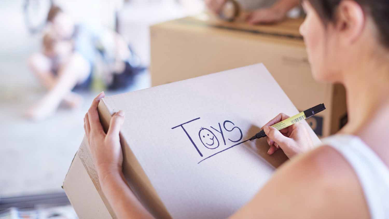 Woman writing on box