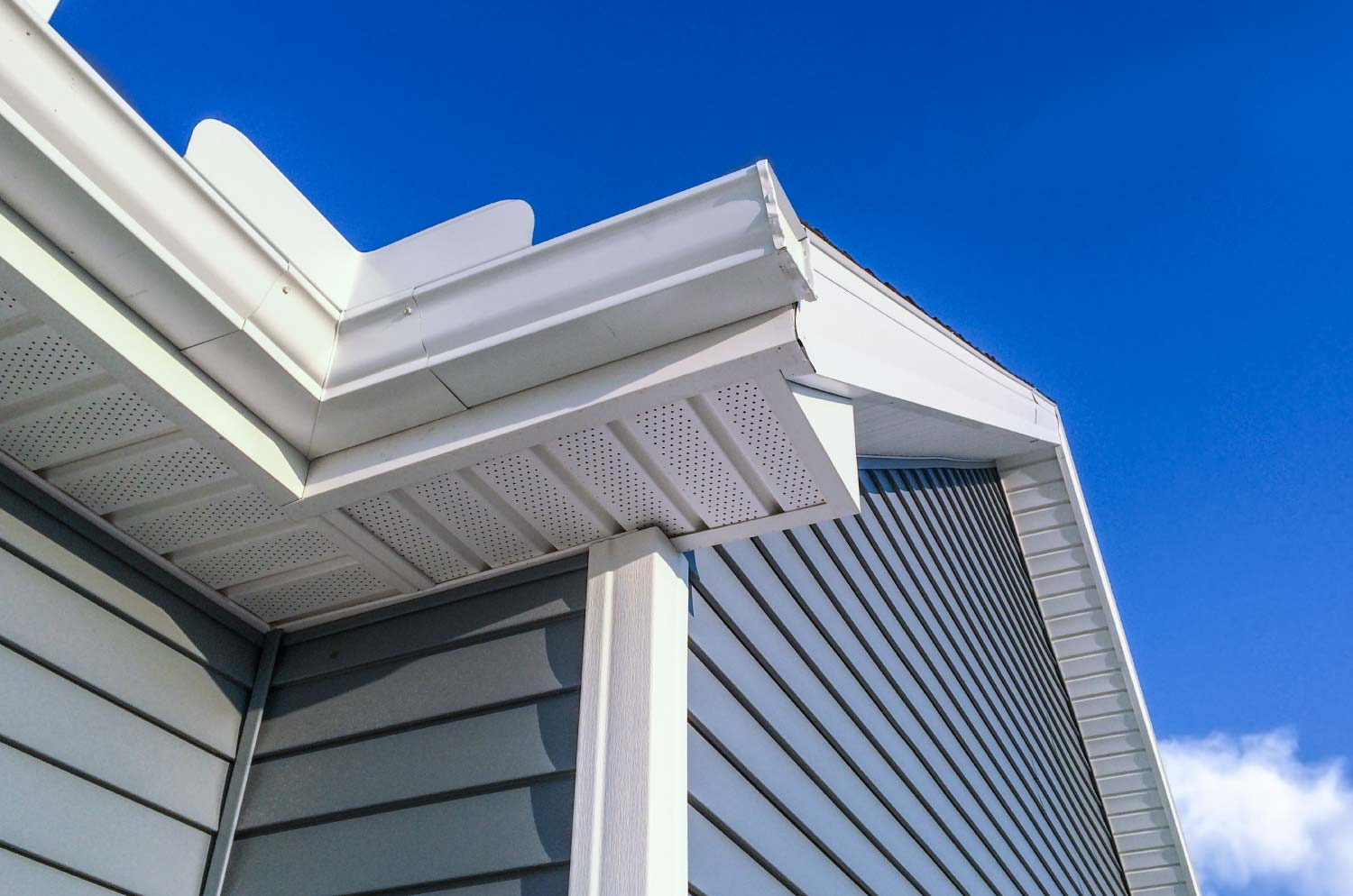 A close up of a wood gutter system