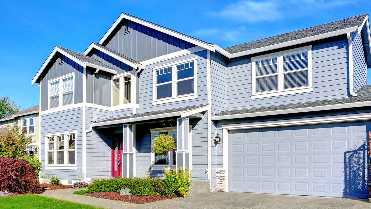Rain gutters installed on a blue two-story house