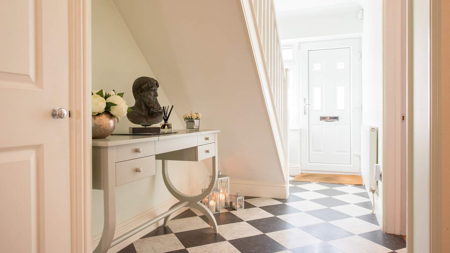 An entryway with ceramic tiles for flooring