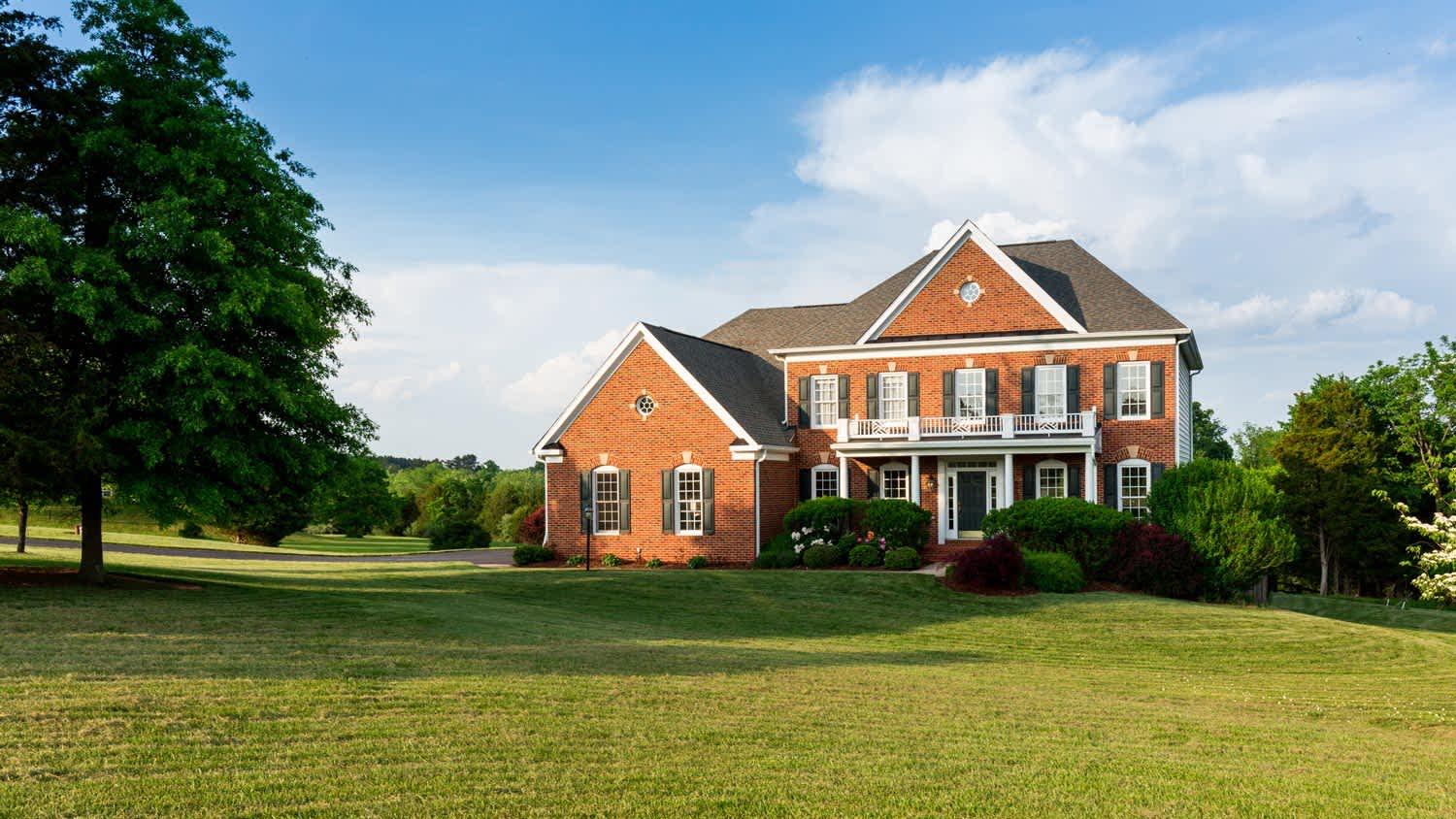 Brick family home sitting in large yard