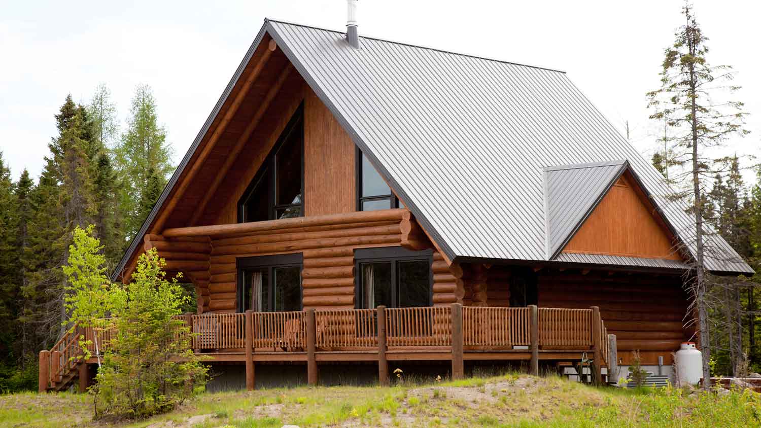 Concrete log siding cabin with metal roof