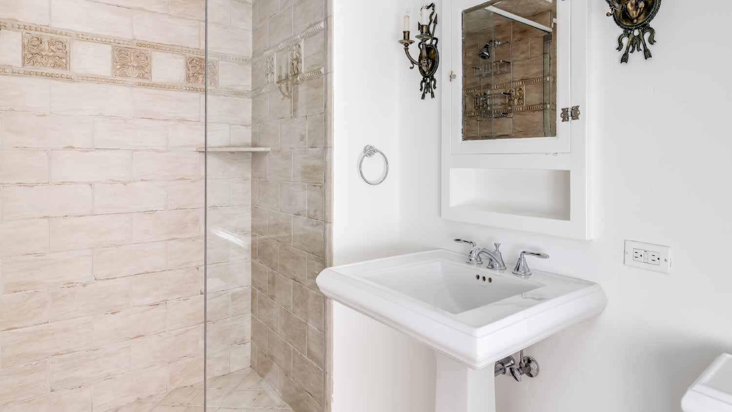 A small bathroom with medieval style light