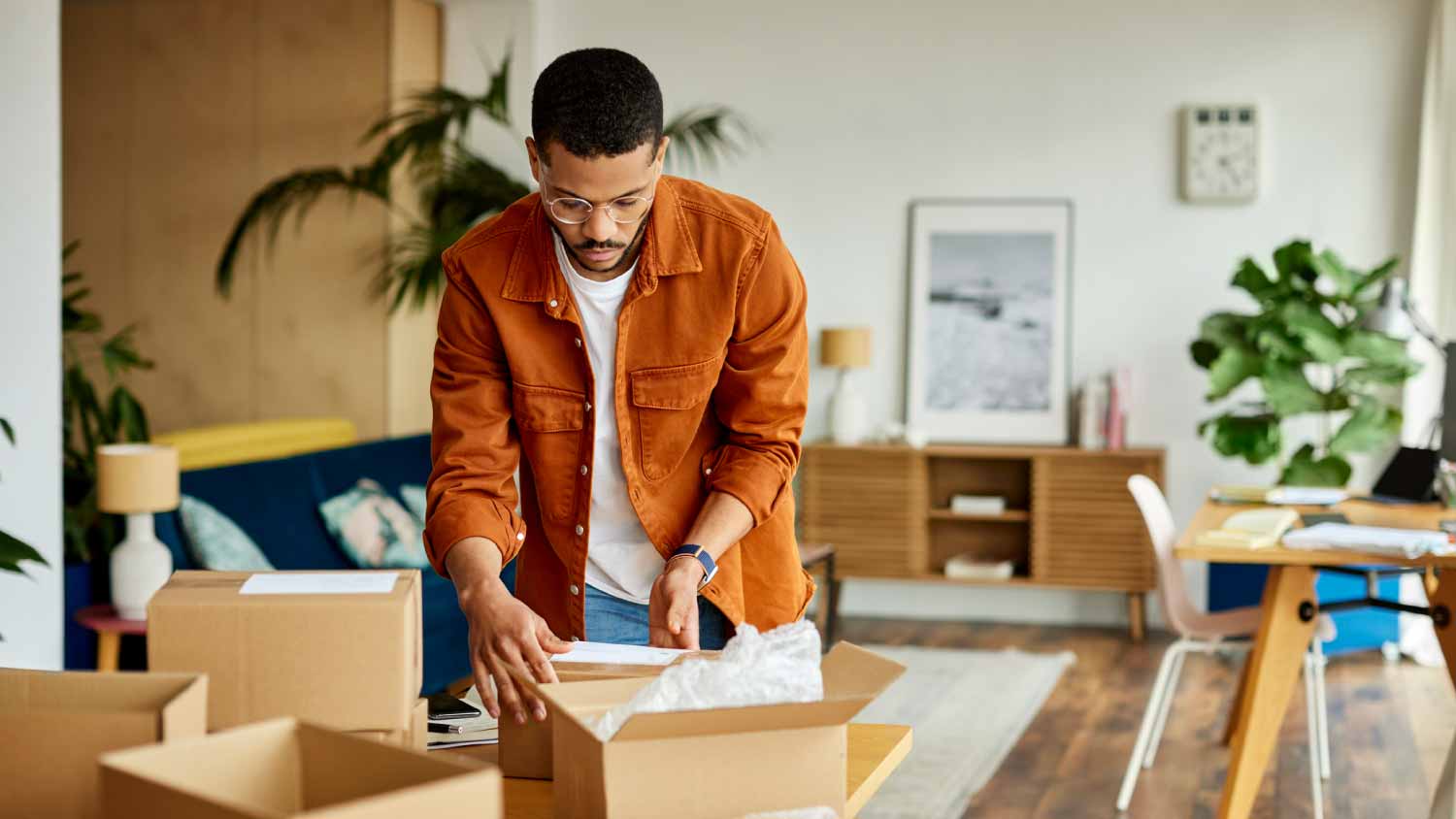 Man packing cardboard box