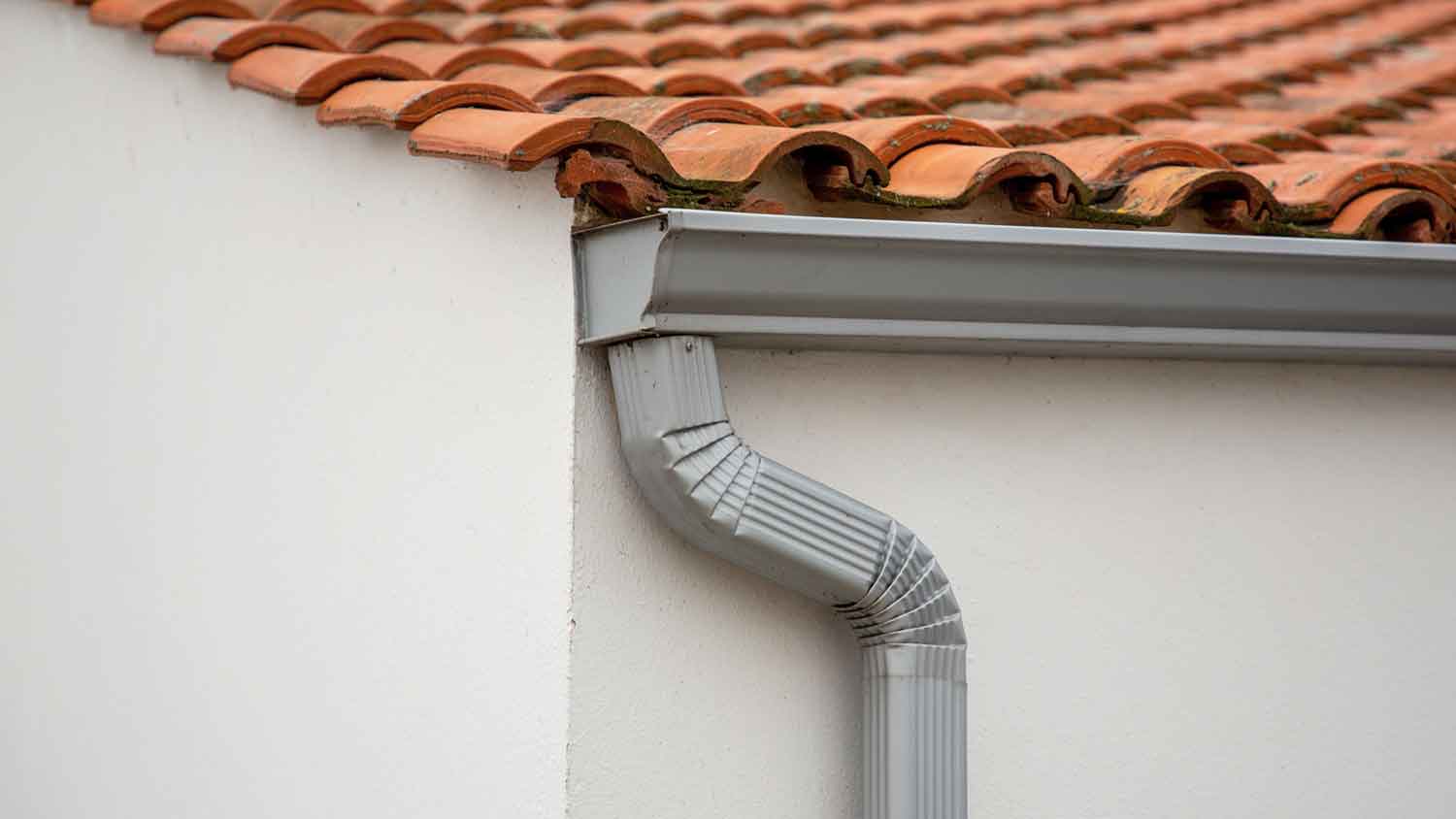 Rain gutter downspout installed on the side of the house